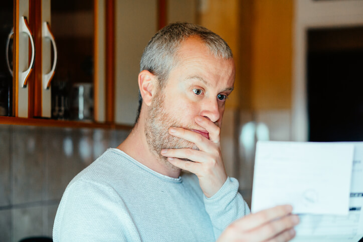 A person looking at their driving record with a concerned expression