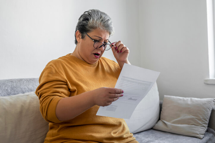 A person looking at a driving record with a traffic violation marked on it